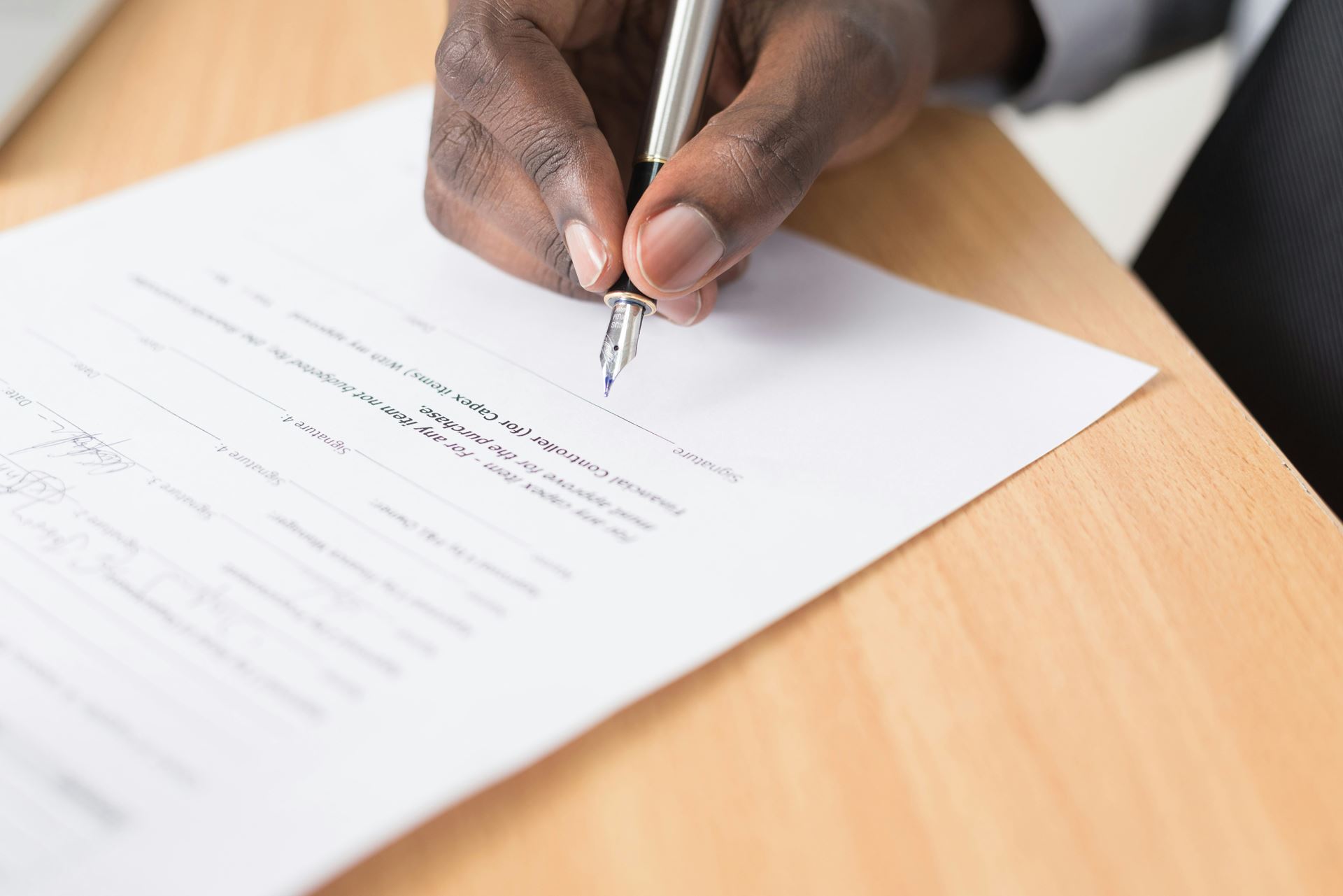 person writing on a form